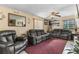 The spacious living room features comfortable seating, a ceiling fan, and natural light at 2213 Bates Ave, Eustis, FL 32726