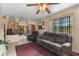 Comfortable living room featuring a ceiling fan and large windows at 2213 Bates Ave, Eustis, FL 32726