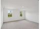 Spacious bedroom with soft carpet, bright windows, and neutral walls at 2467 Zuni Road, St Cloud, FL 34771