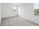 This carpeted bedroom features two windows, white walls and baseboards at 2467 Zuni Road, St Cloud, FL 34771