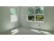 Well-lit room with large windows overlooking picturesque views, perfect for creating a serene retreat at 2467 Zuni Road, St Cloud, FL 34771
