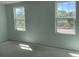 Bright bedroom featuring multiple windows allowing natural light, ideal for relaxation and comfort at 2467 Zuni Road, St Cloud, FL 34771