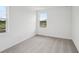 This carpeted bedroom features two windows, white walls and baseboards at 2467 Zuni Road, St Cloud, FL 34771