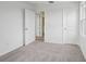 This bedroom features neutral carpet, white walls, a window and doors at 2467 Zuni Road, St Cloud, FL 34771