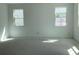 Spacious bedroom with two windows offering natural light and a blank canvas for personalization at 2467 Zuni Road, St Cloud, FL 34771