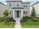 Charming two-story home with gray siding, well-manicured landscaping, and inviting front entrance at 2467 Zuni Road, St Cloud, FL 34771