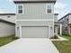 Exterior showcases a two-story home with a gray garage door and driveway at 2467 Zuni Road, St Cloud, FL 34771