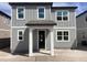 Two-story home featuring gray siding, white trim, and covered front porch with great curb appeal at 2467 Zuni Road, St Cloud, FL 34771