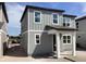 Two-story home featuring gray siding, white trim, and covered front porch and large windows at 2467 Zuni Road, St Cloud, FL 34771