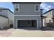 Two-story home with a large front-facing garage and concrete driveway at 2467 Zuni Road, St Cloud, FL 34771