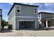 Two-story home with a front-facing garage and modern siding at 2467 Zuni Road, St Cloud, FL 34771