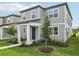Charming two-story home with gray siding, well-manicured landscaping, and inviting front entrance at 2467 Zuni Road, St Cloud, FL 34771