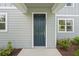 Inviting front door with white trim, modern house number, and neatly landscaped surroundings at 2467 Zuni Road, St Cloud, FL 34771