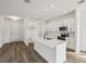 Modern kitchen boasts white cabinets, a center island, and stainless steel appliances at 2467 Zuni Road, St Cloud, FL 34771