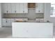New kitchen featuring white cabinets, modern hardware, and an island ready for customization at 2467 Zuni Road, St Cloud, FL 34771