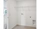 Clean laundry room with tile flooring and utility connections at 2467 Zuni Road, St Cloud, FL 34771