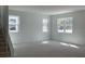 Open-concept living room featuring ample natural light, stairs to the second floor at 2467 Zuni Road, St Cloud, FL 34771