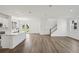 Open living space with modern kitchen, dining area, and staircase, featuring stylish hardwood floors at 2467 Zuni Road, St Cloud, FL 34771