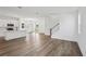Open living space with modern kitchen, dining area, and staircase, featuring stylish hardwood floors at 2467 Zuni Road, St Cloud, FL 34771
