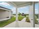 Covered patio featuring lush green grass, walkway and landscaping at 2467 Zuni Road, St Cloud, FL 34771