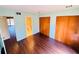 Bright bedroom featuring wood floors, mint walls, closet with doors, and en-suite bathroom access at 248 Crown Oaks Way, Longwood, FL 32779