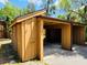 A detached carport with a storage room attached is painted a shade of yellow at 248 Crown Oaks Way, Longwood, FL 32779