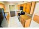 This kitchen features updated appliances, granite countertops, tiled floors and views into the living areas at 248 Crown Oaks Way, Longwood, FL 32779