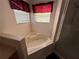 Relaxing corner bathtub with jets, complemented by red window treatments at 2530 Baykal Dr, Kissimmee, FL 34746