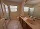 Bathroom featuring a double sink vanity, toilet, and a shower/tub combination at 2530 Baykal Dr, Kissimmee, FL 34746
