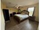 Spacious bedroom with wood floors, a ceiling fan, and ensuite bathroom at 2530 Baykal Dr, Kissimmee, FL 34746