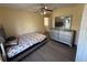 Bedroom with hardwood floors, ceiling fan, and ample dresser storage at 2530 Baykal Dr, Kissimmee, FL 34746
