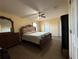 Spacious bedroom featuring wood floors, ceiling fan, and a large decorative mirror at 2530 Baykal Dr, Kissimmee, FL 34746