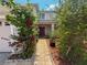 Inviting front entrance with tiled walkway and vibrant landscaping leading to a striking red front door at 2530 Baykal Dr, Kissimmee, FL 34746