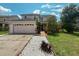 Charming two-story home featuring a well-manicured front yard, two-car garage, and beautiful landscaping at 2530 Baykal Dr, Kissimmee, FL 34746