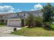 Inviting two-story home with lush landscaping, well-maintained lawn, and attached two-car garage at 2530 Baykal Dr, Kissimmee, FL 34746