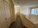 Upstairs hallway featuring wood floors and natural light from window at 2530 Baykal Dr, Kissimmee, FL 34746