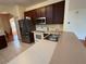 Open kitchen with stainless steel appliances, a stone countertop, and updated fixtures at 2530 Baykal Dr, Kissimmee, FL 34746