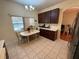 Eat-in kitchen featuring tile floors, stainless steel appliances, and a breakfast nook with bright window at 2530 Baykal Dr, Kissimmee, FL 34746