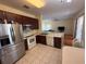 Open concept kitchen featuring stainless steel appliances and a breakfast bar that leads to the living room at 2530 Baykal Dr, Kissimmee, FL 34746