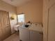 Laundry room with a washer, dryer, utility sink, and storage space at 2530 Baykal Dr, Kissimmee, FL 34746