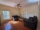 Inviting living room with tile flooring, neutral paint colors, and comfortable furniture under a ceiling fan at 2530 Baykal Dr, Kissimmee, FL 34746