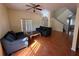 Cozy living room featuring tile floors, a ceiling fan, and comfortable seating arrangements at 2530 Baykal Dr, Kissimmee, FL 34746