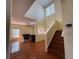 Open-concept living area with tile flooring, a soaring ceiling, and access to the staircase and other rooms at 2530 Baykal Dr, Kissimmee, FL 34746