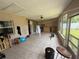 Enclosed patio space with tiled flooring, open windows, and casual seating at 2530 Baykal Dr, Kissimmee, FL 34746