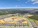 A grand aerial perspective captures homes near the ongoing development, complemented by lush green spaces and scenic lake views at 2766 Purple Meadow Ct, Minneola, FL 34715