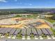 An aerial view of houses near a construction site with beautiful landscaping and community planning at 2766 Purple Meadow Ct, Minneola, FL 34715