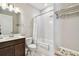 Bright bathroom with a shower-tub combo, white tile, and modern vanity at 2766 Purple Meadow Ct, Minneola, FL 34715