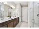 Luxurious primary bathroom with double vanity and glass-enclosed shower at 2766 Purple Meadow Ct, Minneola, FL 34715