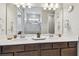 Elegant bathroom with dual sinks, quartz countertops, and a view into the shower at 2766 Purple Meadow Ct, Minneola, FL 34715