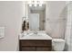 Well-lit bathroom featuring a modern vanity with a white countertop and undermount sink at 2766 Purple Meadow Ct, Minneola, FL 34715